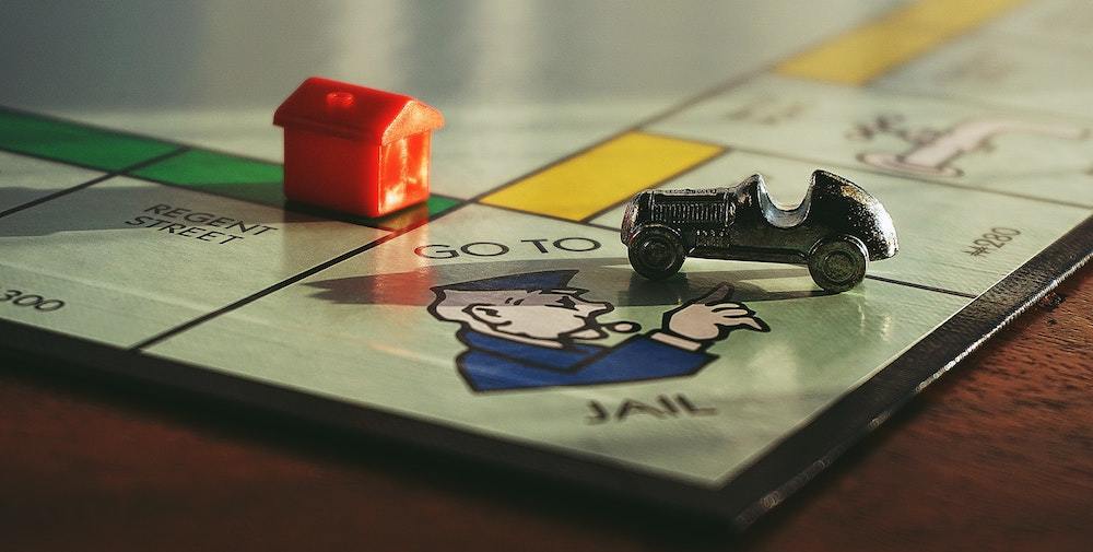 Monopoly board "Go to Jail" square, representing the consequences of investment fraud