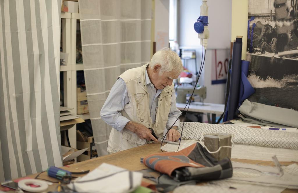 a small business owner cuts cloth and working hours in semi-retirement