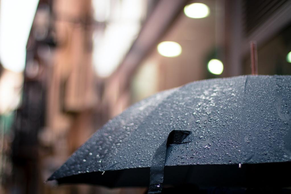 raindrops on a black umbrella, symbolizing the need for a trade credit insurance policy