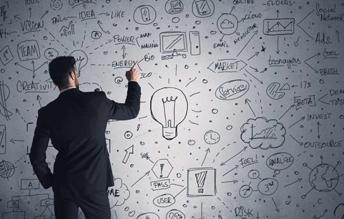 A man whiteboarding ideas